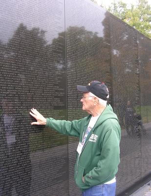 Vietnam veteran touching the Vietnam Wall