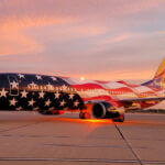 Southwest Airlines "Freedom One" aircraft with a special paint scheme featuring the 50 stars and 13 stripes from the US flag.