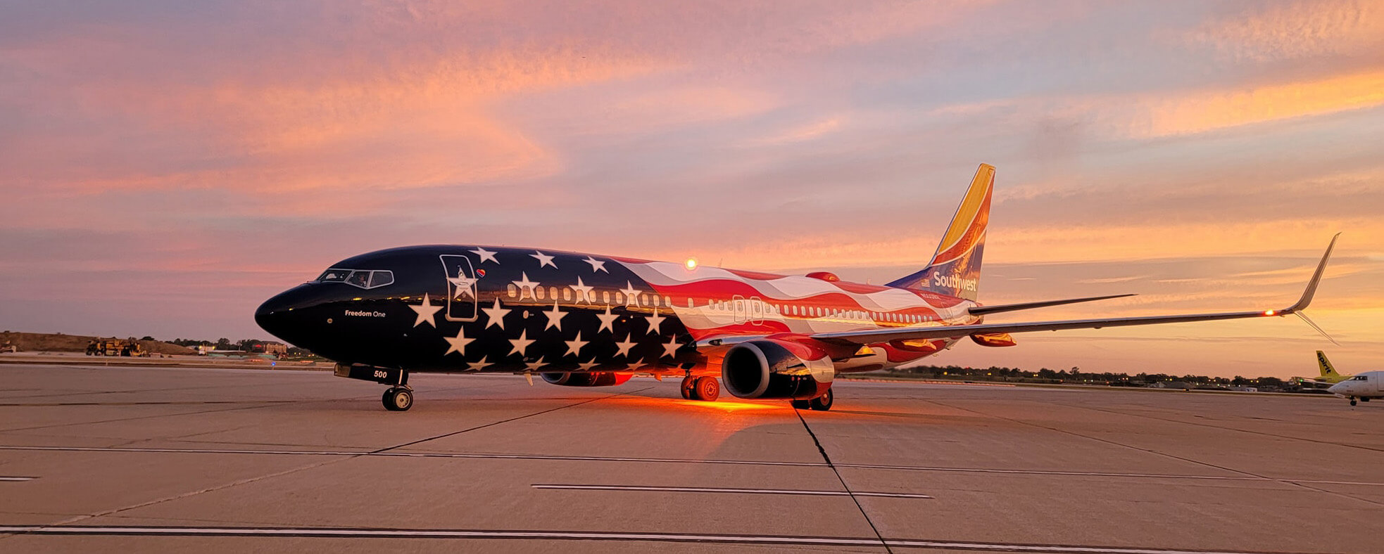 Southwest Airlines "Freedom One" aircraft with a special paint scheme featuring the 50 stars and 13 stripes from the US flag.