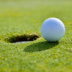 A golf ball that stopped an inch from the cup