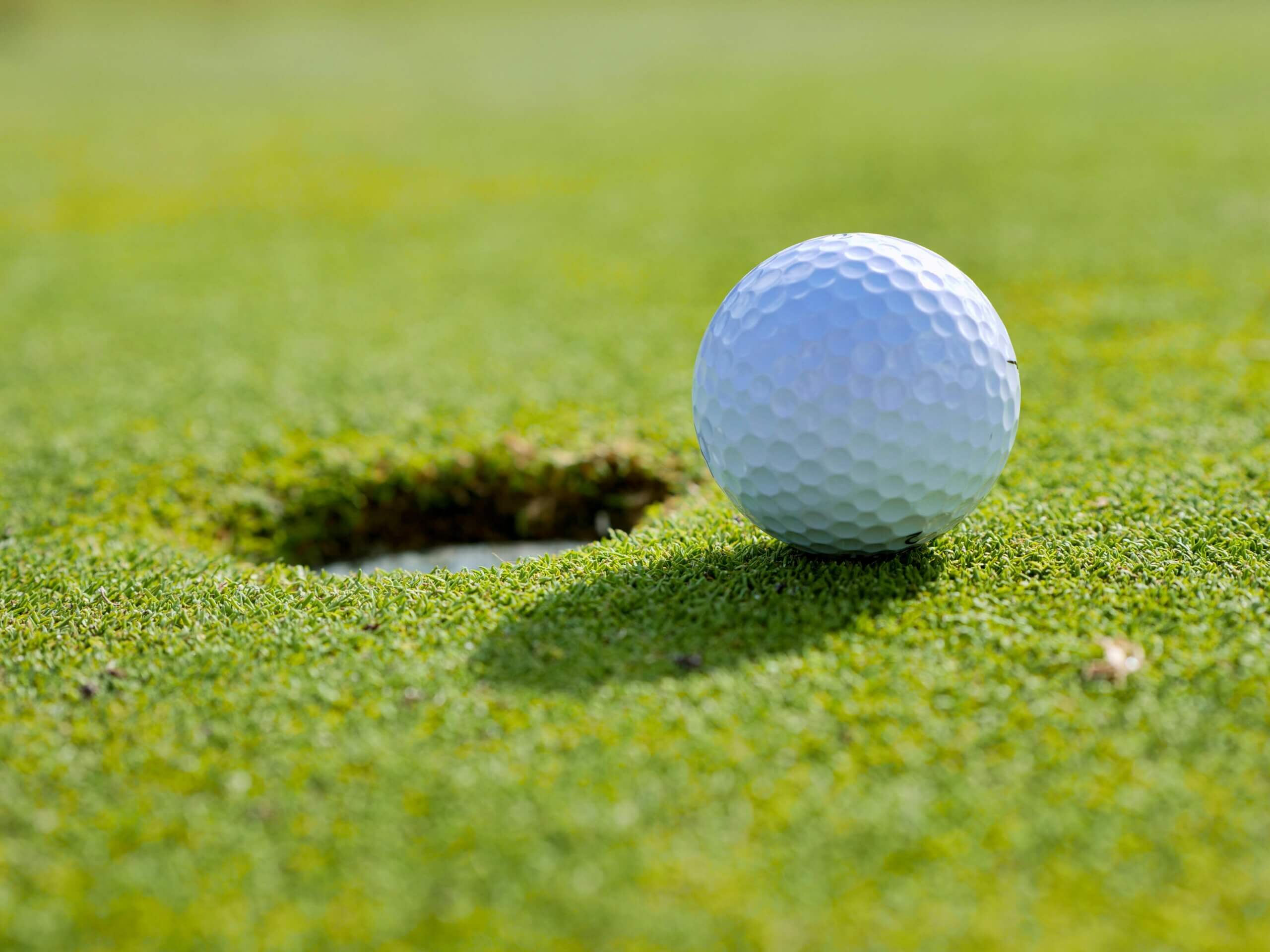 A golf ball that stopped an inch from the cup
